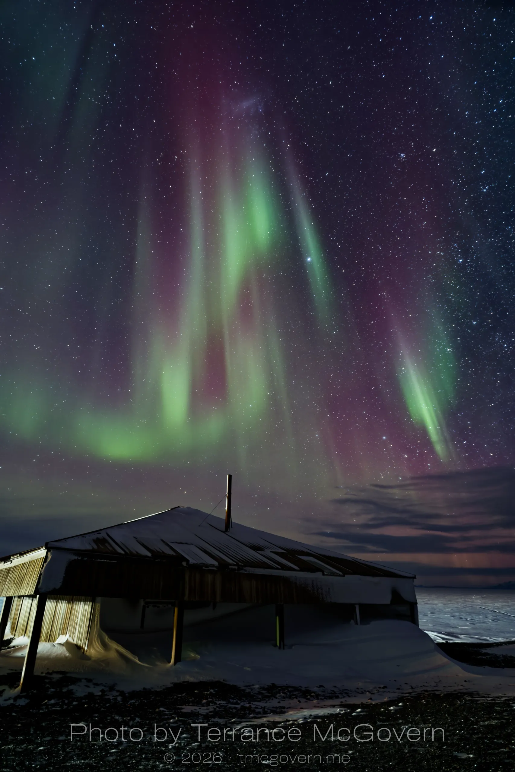 Discovery Hut under auroras